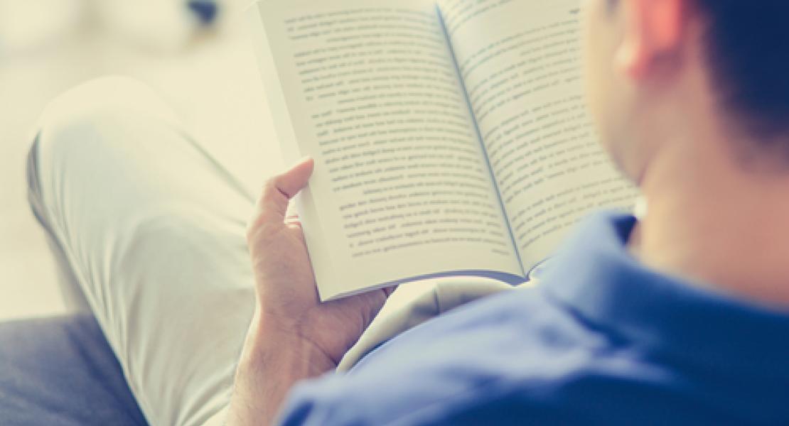 Image of young person reading a book